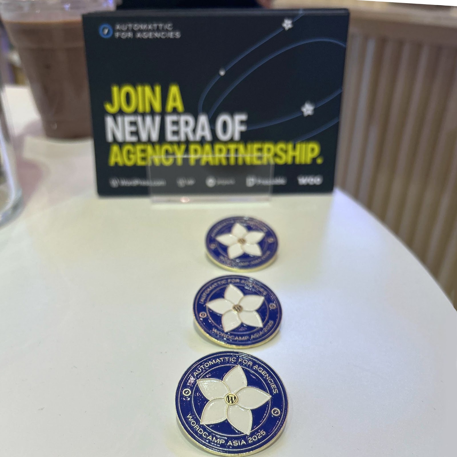 several pins laid out on a table at WordCamp Asia