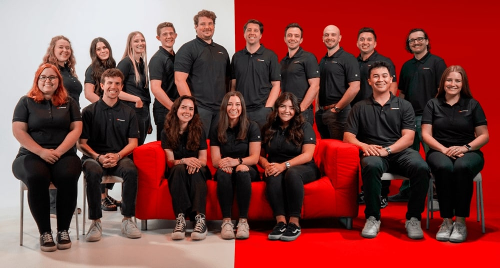 Big Red Jelly team, sitting on a red couch