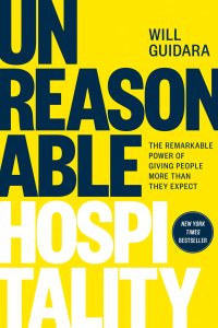 A yellow book cover with the word "UNREASONABLE" in black and "HOSPITALITY" in white