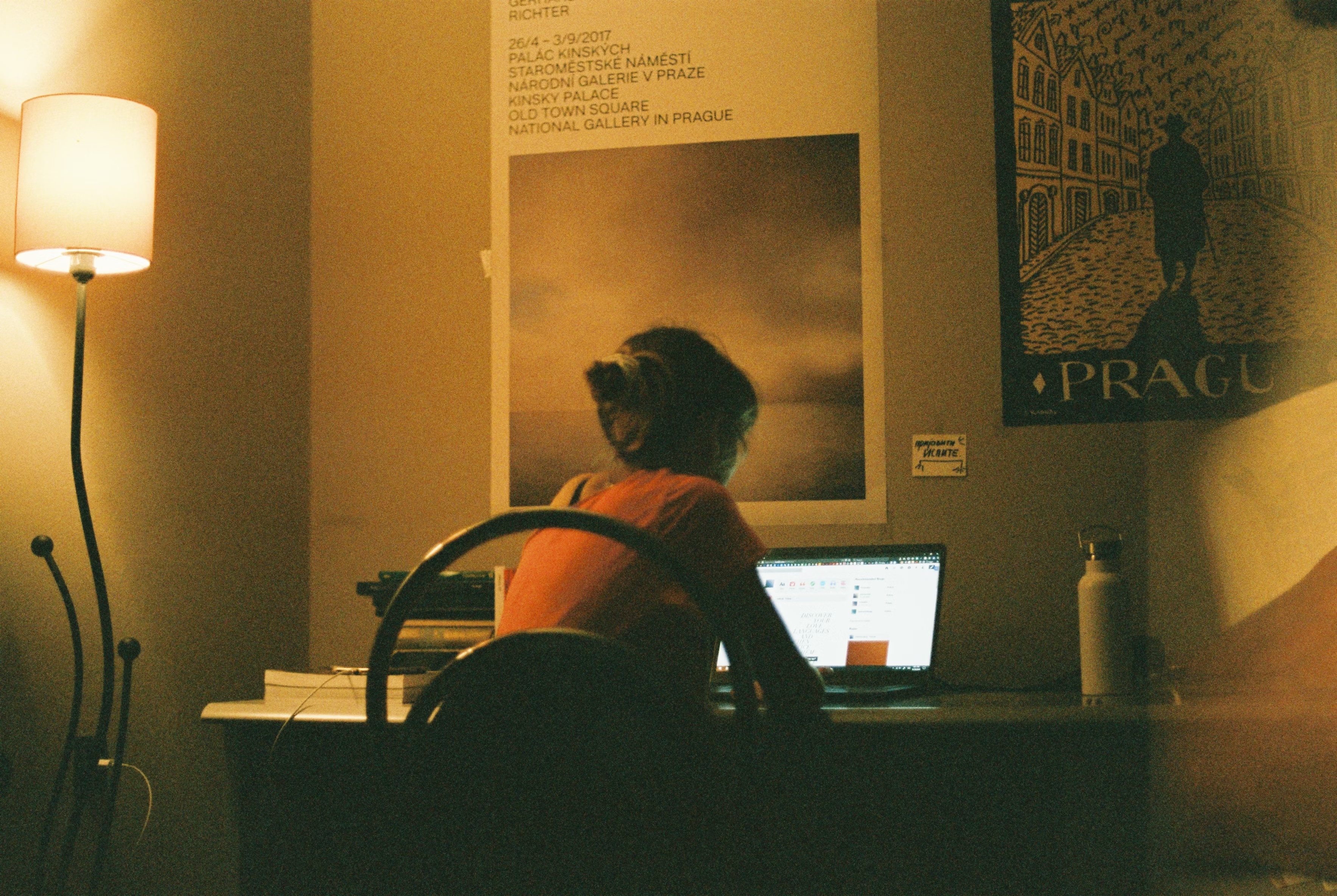 Working from home, courtesy of Unsplash. A woman at a desk in her home office leans into her laptop computer. The photo communicates the sense of peace and quiet that comes with minimally interrupted work.